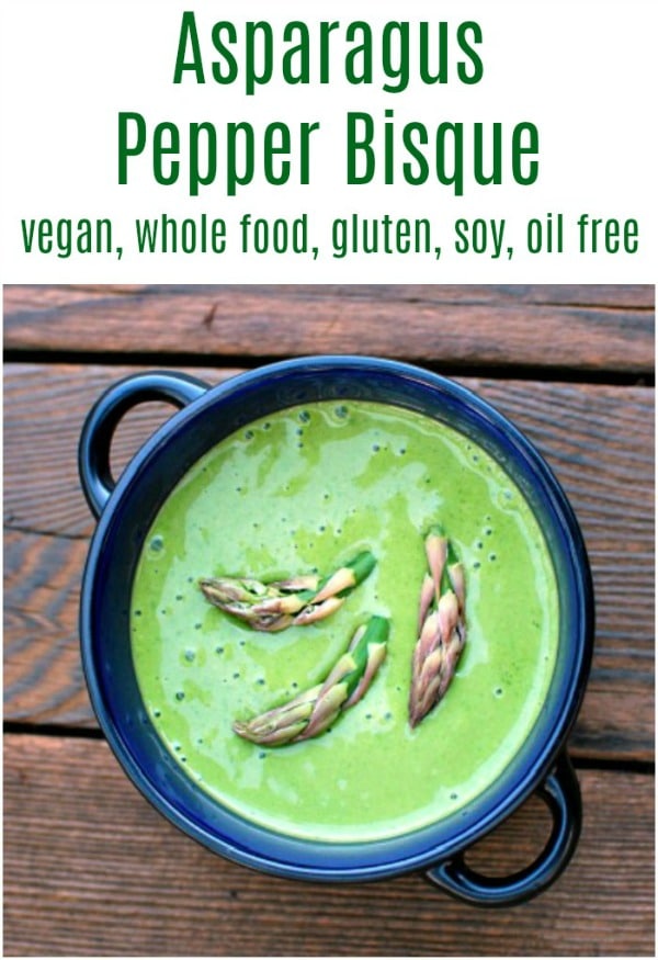 overhead view of a dark blue bowl with bright green asparagus bisque