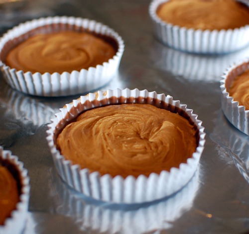 how to make vegan peanut butter cups: topping melted chocolate with peanut butter