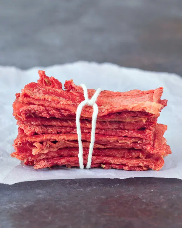 Watermelon candy strips in a stack, tied with twine