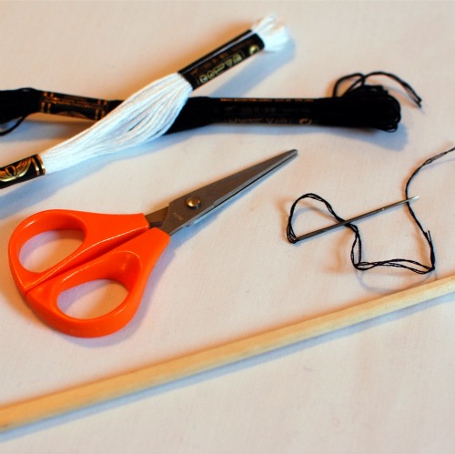 tools to make handmade felt dachshund ornaments: thread, small scissors, chopstick, needle.