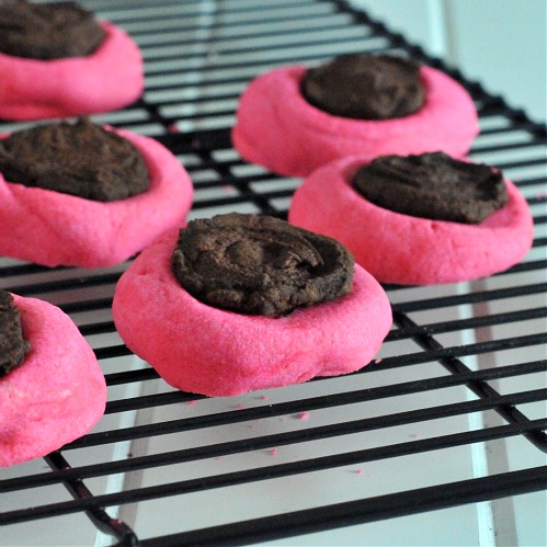 Pink Thumbprint cookies with Whiskey Ganache on a baking rack