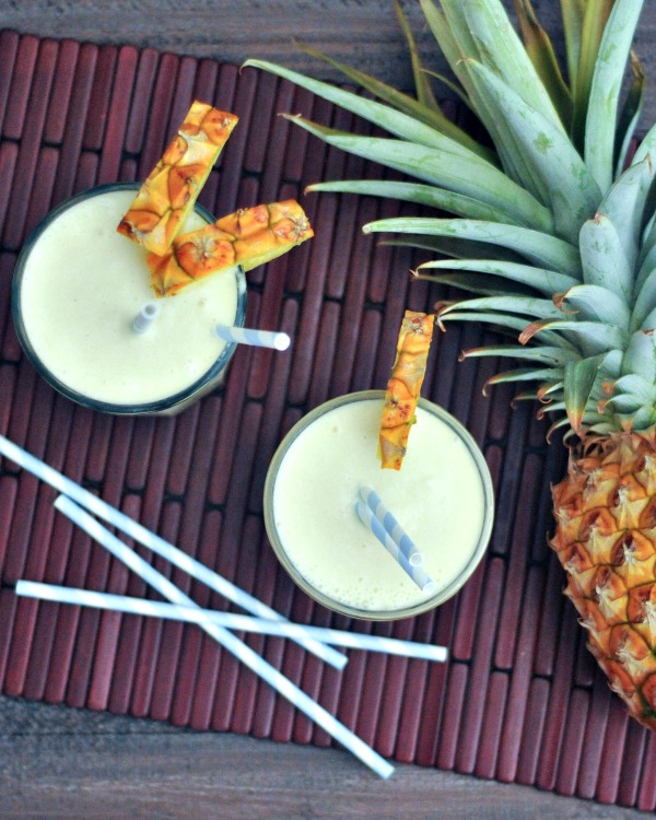 overhead view of vegan cocktails - two Pina Coladas and a pineapple 