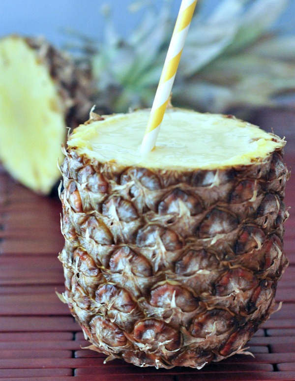 vegan Lightened Up Pina Coladas served in a pineapple
