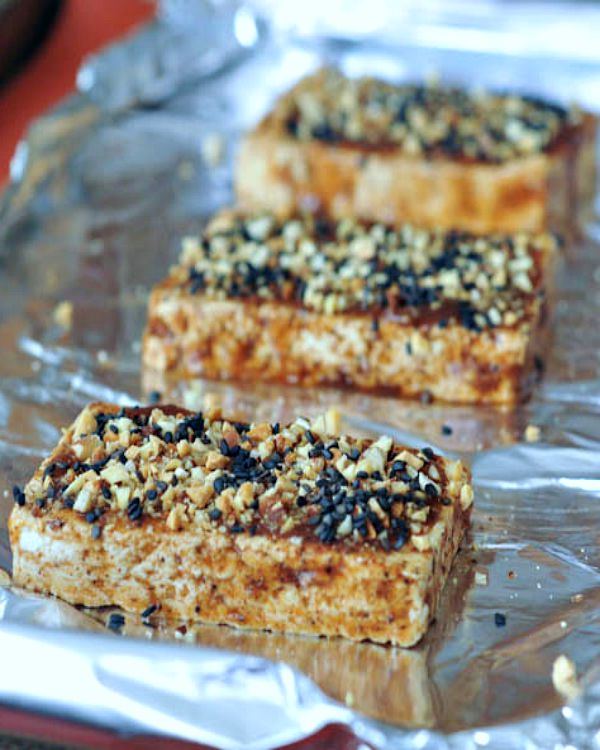 Almond crusted tofu on a foil lined baking sheet