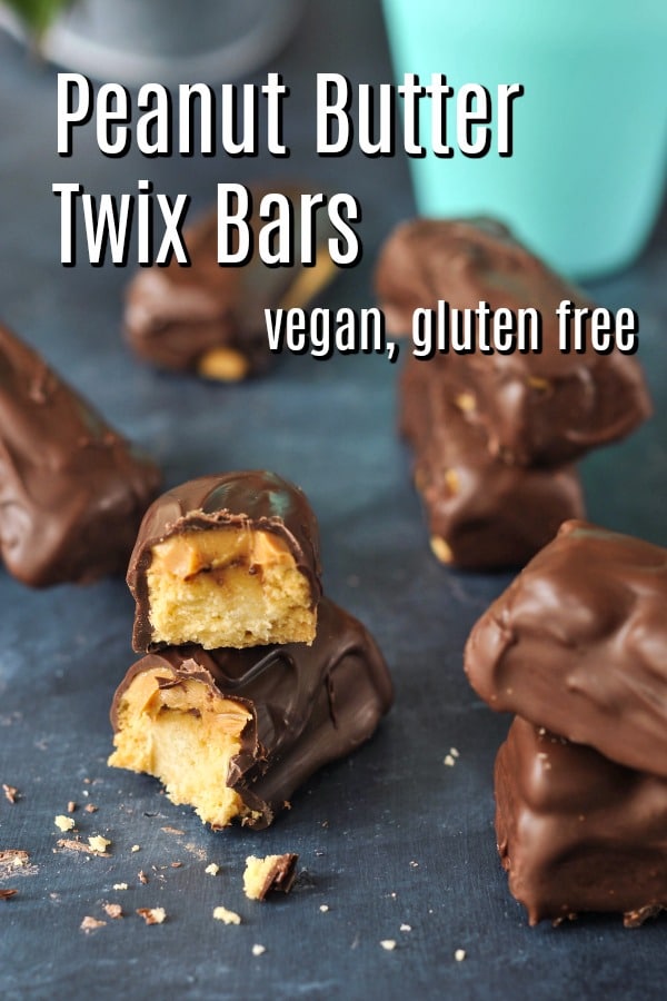 a homemade vegan Twix candy bar broken in half to see the peanut butter and cookie inside.
