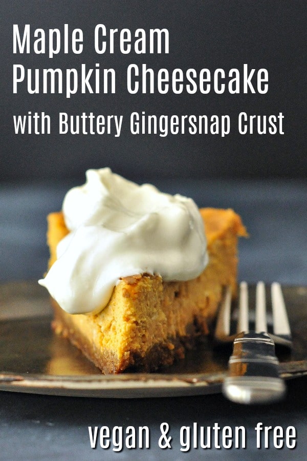a slice of pumpkin cheesecake on a dark grey rustic plate with bright white whipped cream on top.