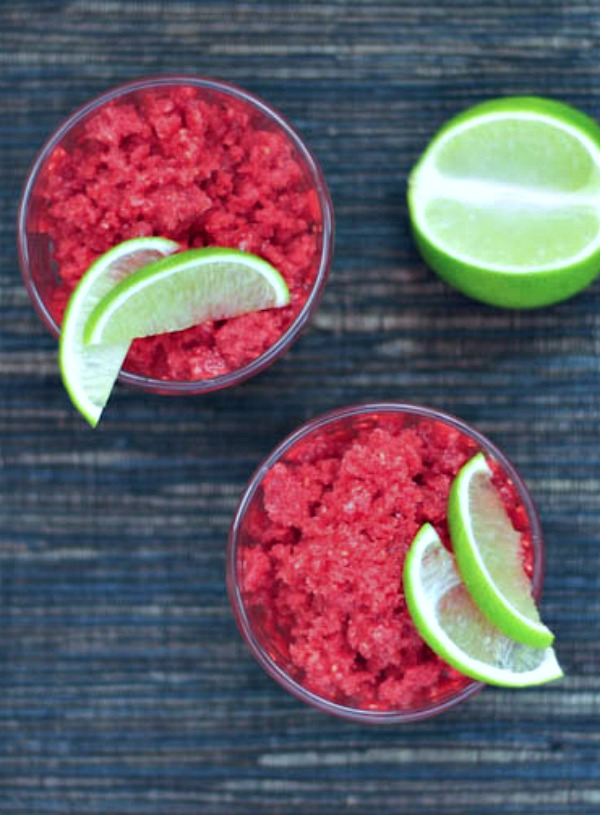 overhead view of iced berry granita served in a glass, garnished with lime wedge