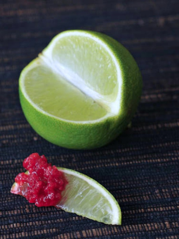 whole lime fruit with one slice cut out