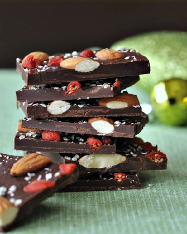 Dark chocolate superfood bark stacked on a green towel