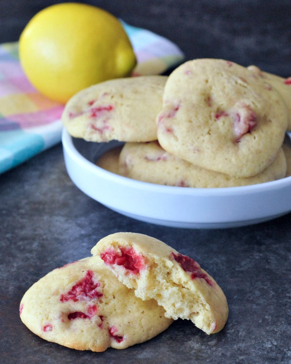 Raspberry Lemon Cheesecake Cookies on a plate, fresh lemon in background