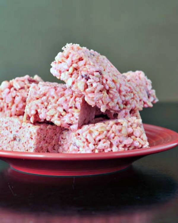 pink Strawberry Lemon Rice Crispies squares stacked on a plate
