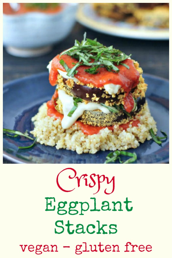 two slices of crispy eggplant stacked on top of quinoa and covered with marinara sauce and fresh chopped basil leaves.