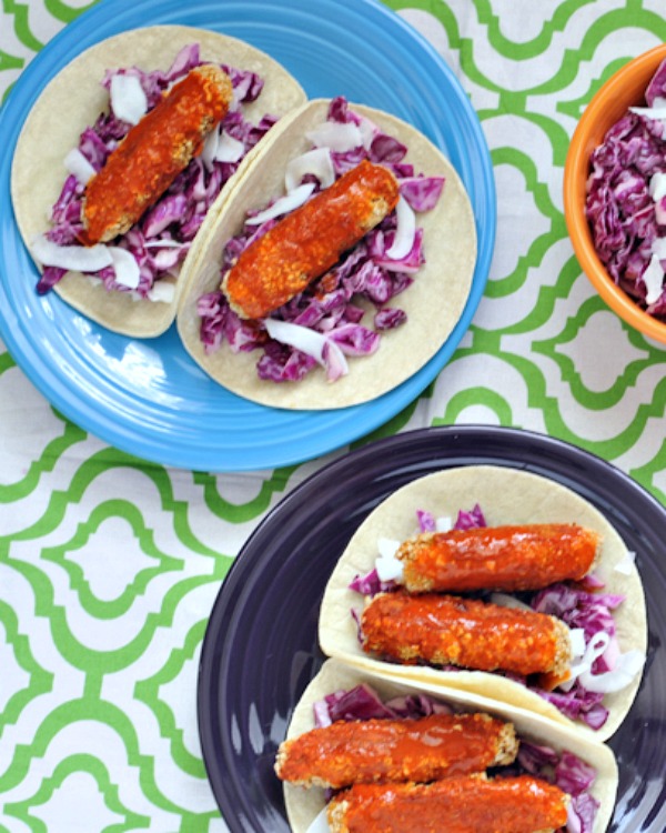 buffalo "chicken" wings on plates with soft taco shells and cabbage