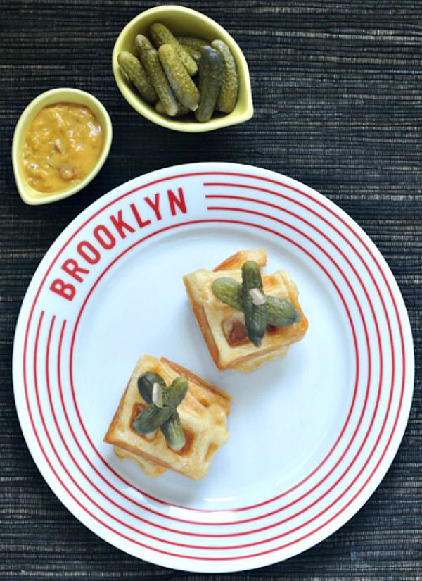 Croque Monsieur Stuffed Waffles on a plate with pickles and mustard for dipping