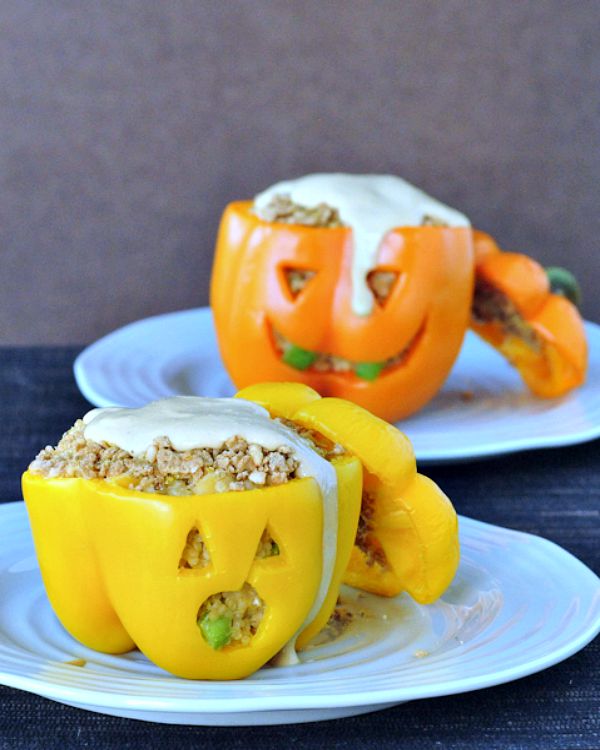 Jalapeno popper mixture (quinoa, cheese, jalapeno) stuffed into orange and yellow bell peppers carved to look like a Halloween jack o lantern.