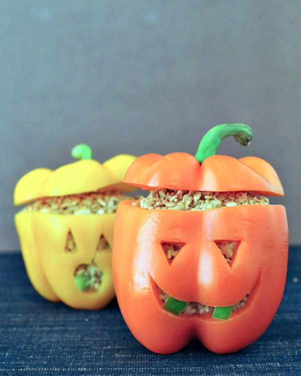 Jalapeno popper mixture (quinoa, cheese, jalapeno) stuffed into orange and yellow bell peppers carved to look like a Halloween jack o lantern.