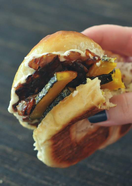 hand holding a Caramelized Kabocha Sandwich with a bite out of it