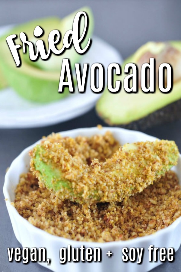 fried avocado slices coated in pecan crumb, half avocado with pit in background