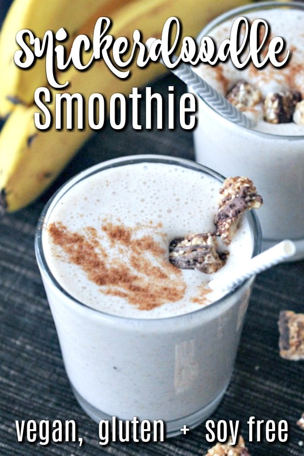 creamy white Snickerdoodle Smoothie in a glass with cinnamon and granola sprinkled on top, bananas in the background