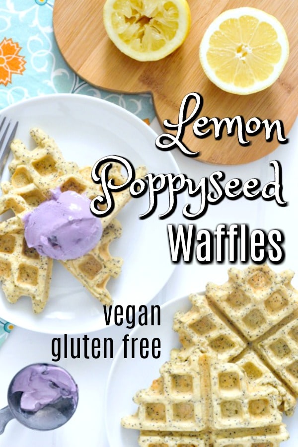 Vegan Lemon Poppyseed Waffles on plates, sliced lemon and blueberry yogurt on side