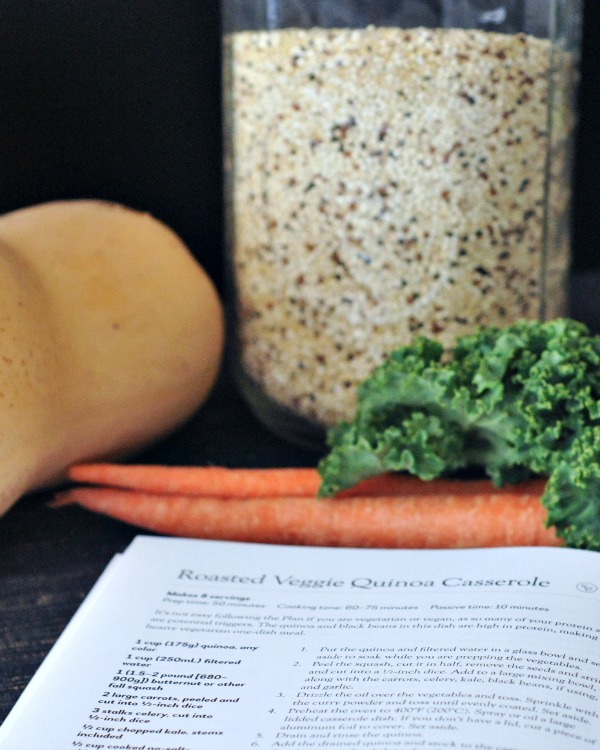 Roasted Veggie Quinoa Casserole ingredients: carrots, whole butternut squash, jar of dry quinoa, cookbook open to recipe