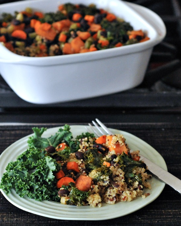 Roasted Veggie Quinoa Casserole on a plate, whole casserole in baking dish on the side