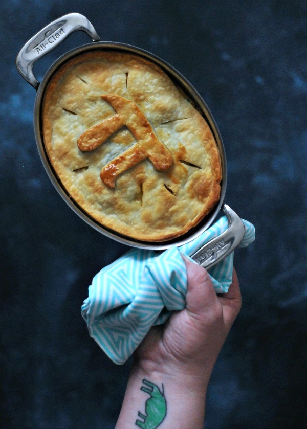 whole Jackfruit Chile Relleno Pot Pie in pan, held by one towel wrapped handle 