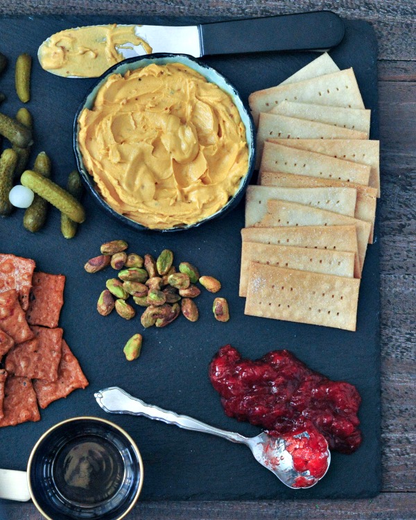 Salt and Vinegar Crackers on a cheeseboard with cheese, knife, cornichon, pistachios, jam
