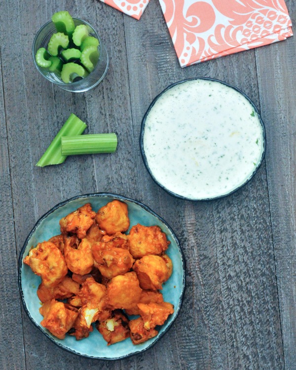 Vegan Air Fryer Buffalo Cauliflower served in a bowl with celery and ranch dressing on the side