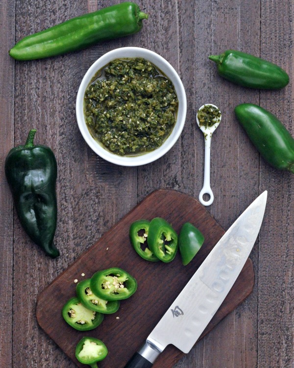 Spicy jalapeño sesame salsa in a bowl, fresh peppers and knife aside