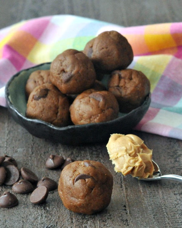 Triple Almond Cookie Dough Bites in bowl, single bite and spoonful of almond butter in front
