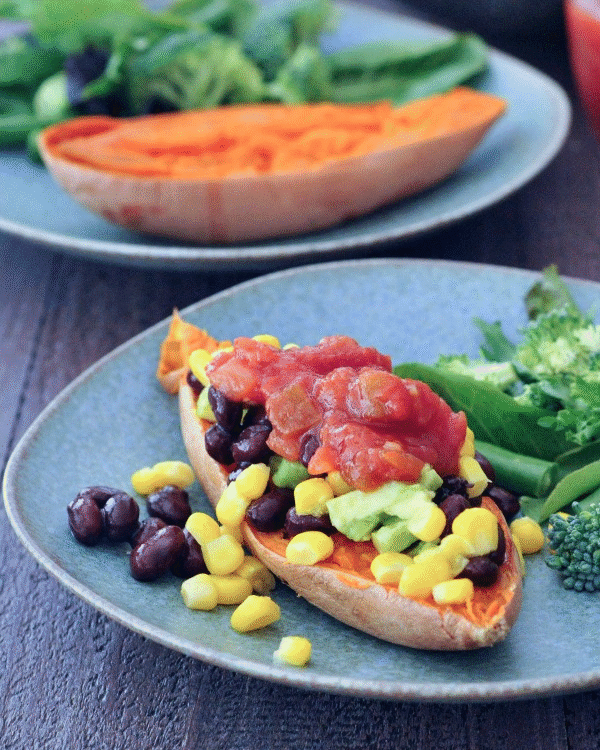 animated gif of cooked sweet potato being stuffed with beans, corn, avocado, and salsa