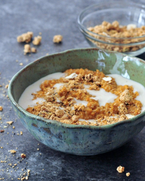 Pumpkin Spice Chia Pudding in a bowl, swirled with cashew cream and topped with granola