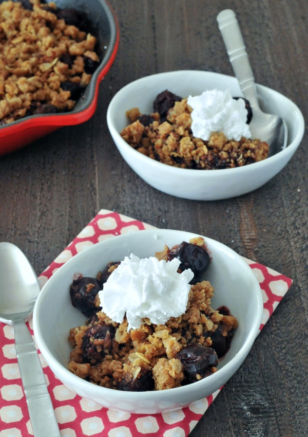 chocolate cherry crisp in bowls with whip cream