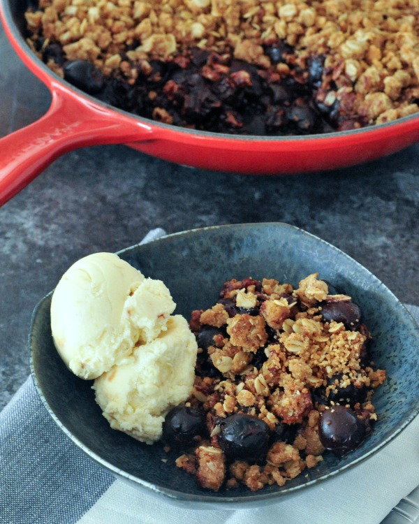 chocolate and cherry crisp in bowl with ice cream