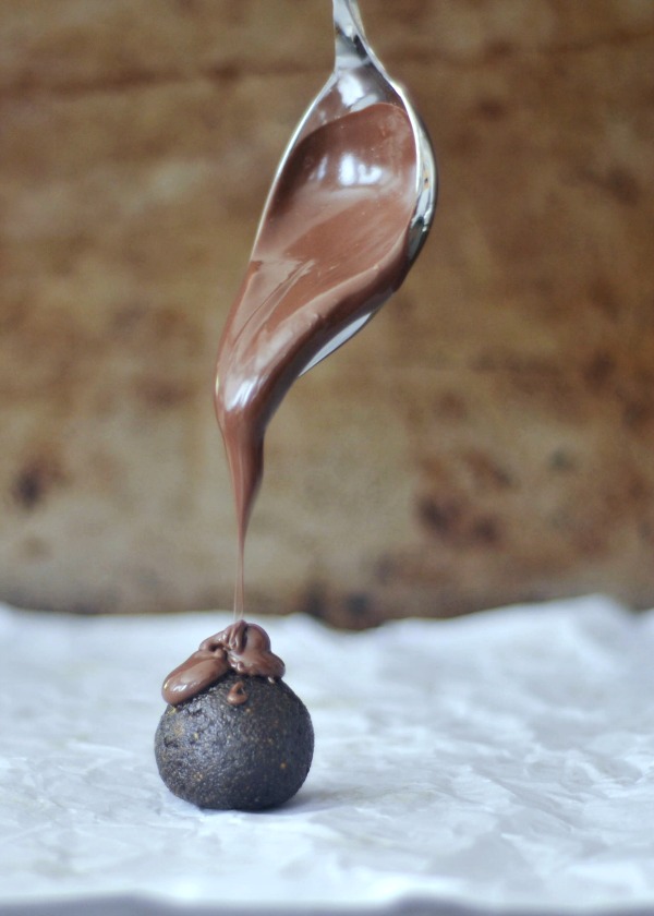 melted chocolate spooned over an Oreo Cashew Truffle