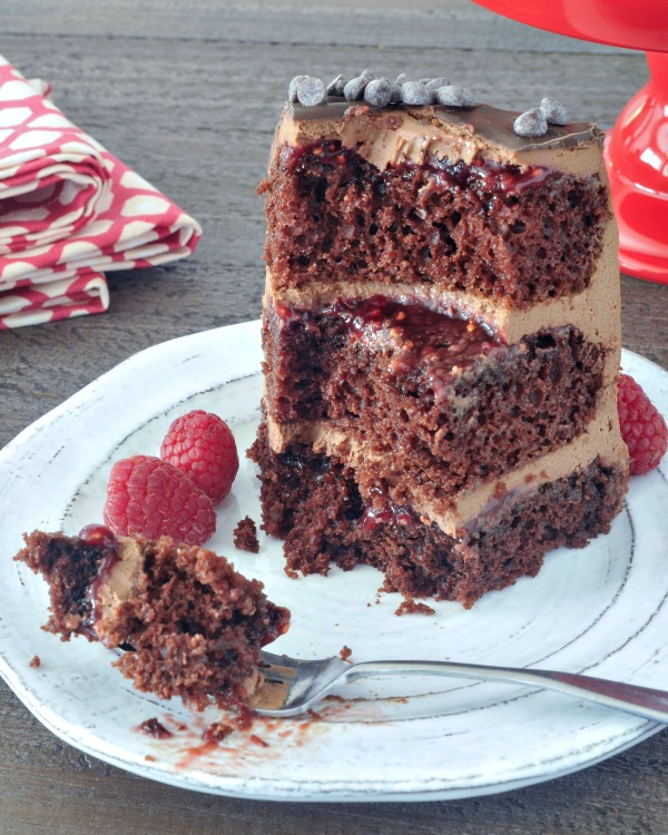 slice of Delectably Rich Vegan Chocolate Mousse Cake with several bites missing, bite of cake on fork