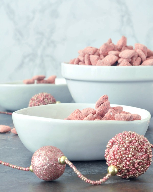 Powder Pink Strawberry Puppy Chow in bowls (a strawberry powder and chocolate coated cereal treat)