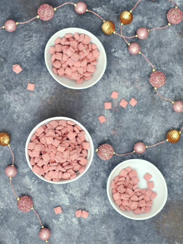 Powder Pink Strawberry Puppy Chow in bowls for snacking (a strawberry powder and chocolate coated cereal treat)