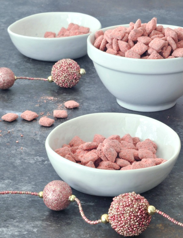 Powder Pink Strawberry Puppy Chow in small bowls for snacking (a strawberry powder and chocolate coated cereal treat)