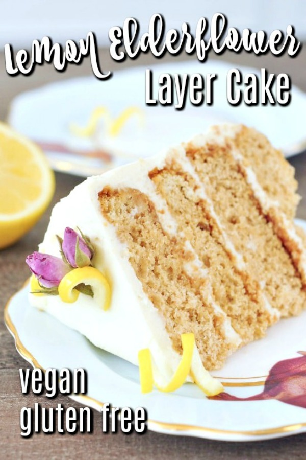 slice of Lemon Elderflower Cake with white frosting on a tea saucer, slice of lemon in background