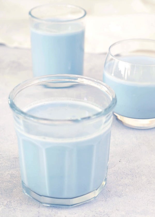 pale blue vanilla mint cashew milk in three various clear glasses