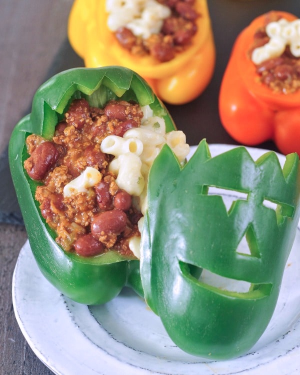 Chili mac filling in a green bell pepper carved to look like a Halloween Frankenstein monster face.