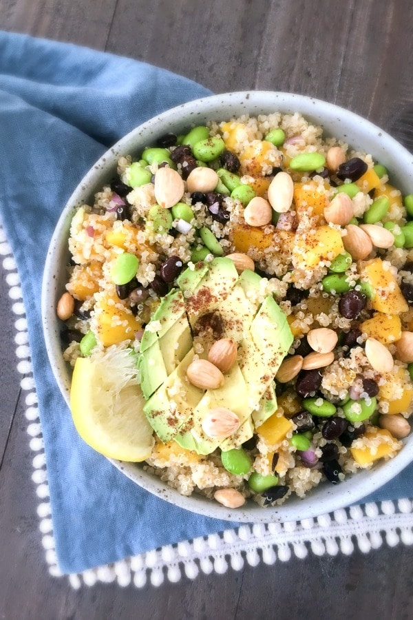 Mango Black Bean Salad in a bowl with squeezed lemon and cubed avocado