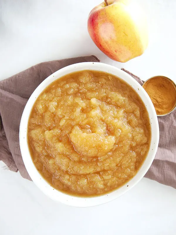 overhead view of Instant Pot Applesauce, whole apple on the side