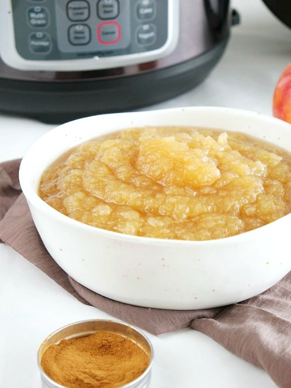 Instant Pot Applesauce in a bowl, Instant Pot in background