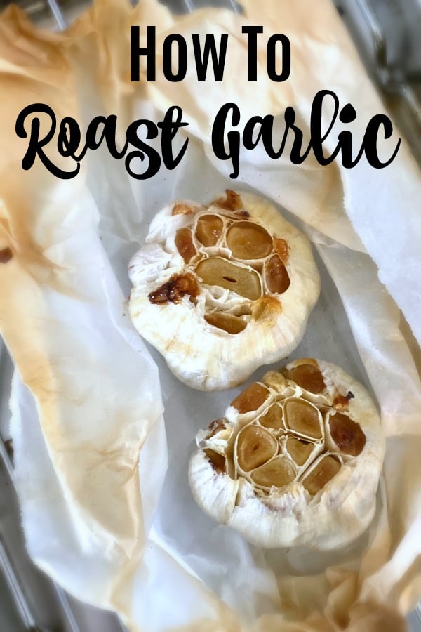 two whole bulbs of roasted garlic, wrapped in browned parchment paper