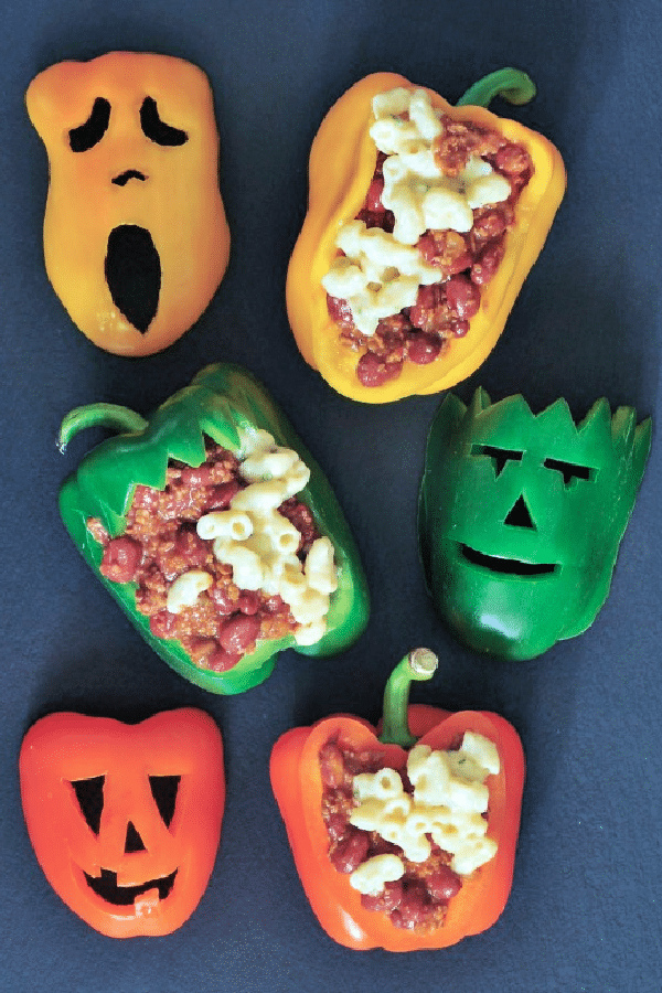 chili mac stuffed bell peppers with Halloween faces carved into the peppers