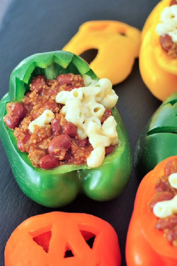 bell peppers carved into Halloween faces, stuffed with chili and cheesy mac