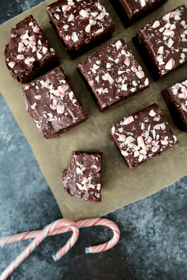overhead view of sliced brownie squares, frosted with the best brownie frosting and sprinkled with crushed candy cane pieces.